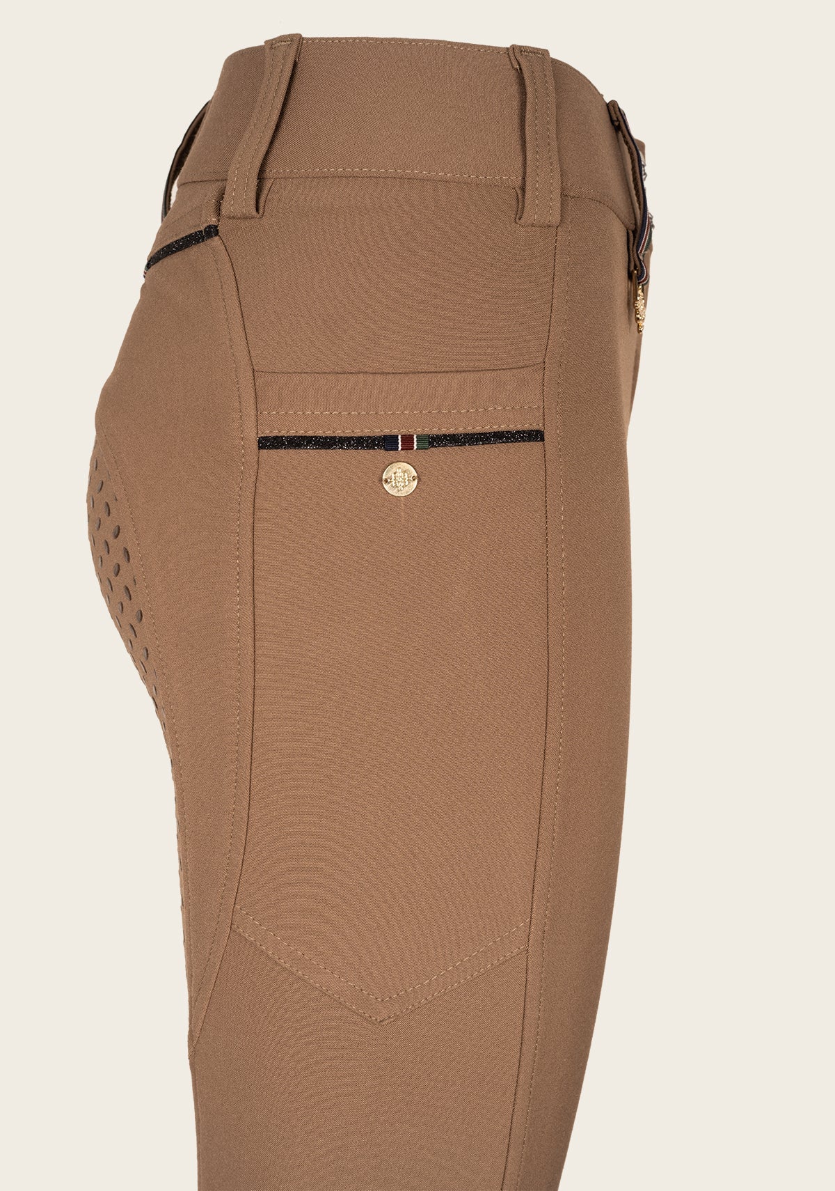 Close-up of Espoir breech phone pocket with custom golden nameplate and tone-on-tone glitter zip detail.