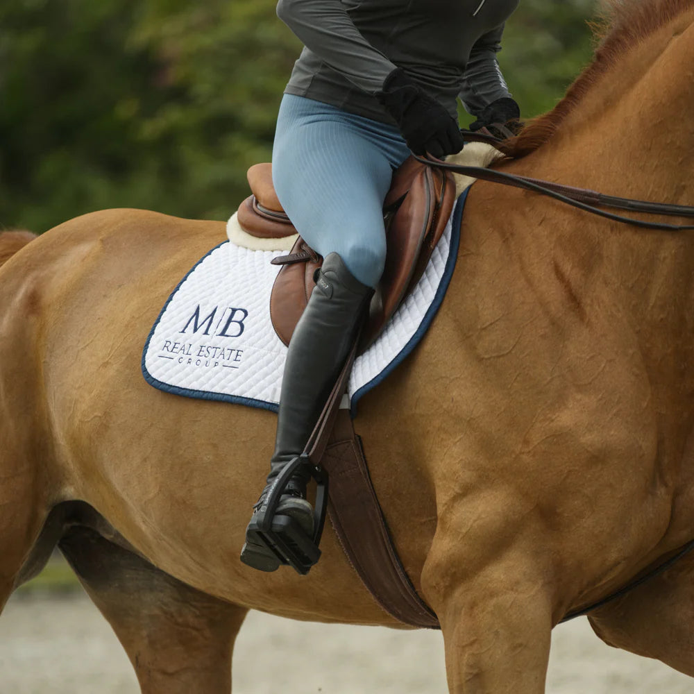 - Herm Sprenger Aero stirrups in use, shown on horse with rider in motion
