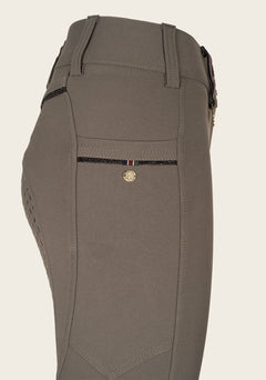 Close-up of Espoir breech phone pocket with custom golden nameplate and glitter zip detail.