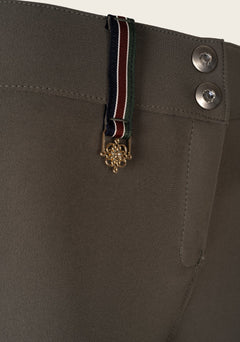 Detail view of Espoir breech crossed back belt loop in brand colors, showcasing signature design element.