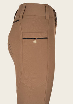 Close-up of Espoir breech phone pocket with custom golden nameplate and tone-on-tone glitter zip detail.