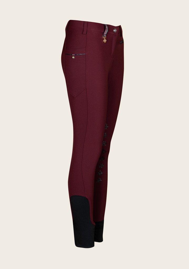 Side profile of Espoir breech highlighting phone pocket with golden nameplate and contoured seam lines.