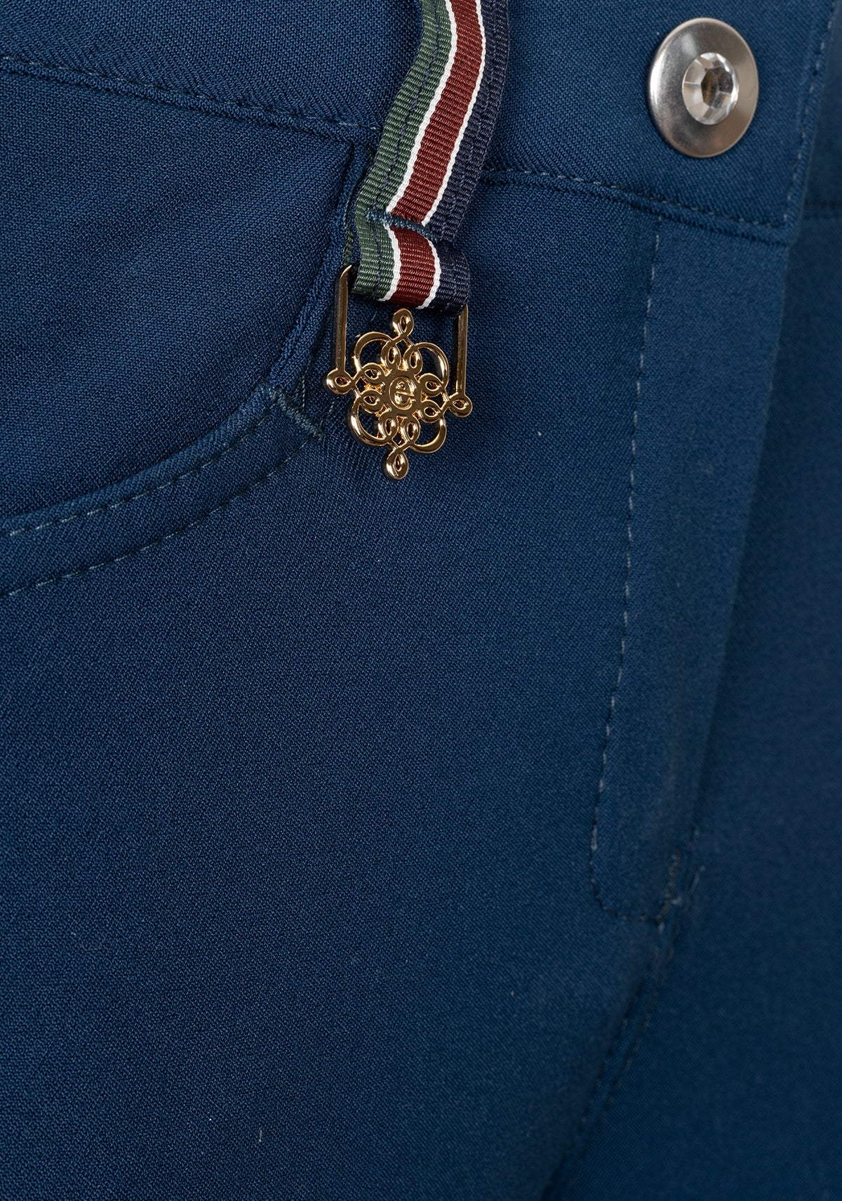 Close-up of Espoir breech pocket with custom golden nameplate and tone-on-tone zip detail.