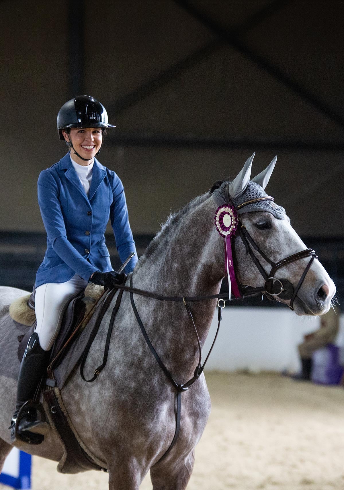 Equestrian rider wearing Espoir show jacket while sitting on a gray horse, showcasing athletic fit and lightweight summer-ready design.